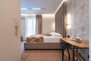 Ένα ή περισσότερα κρεβάτια σε δωμάτιο στο LOLA Apartments