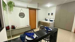 a hotel room with a bed and a table and chairs at 308-1 · Suíte Luxo Unievangélica/Ânima. 308 in Anápolis