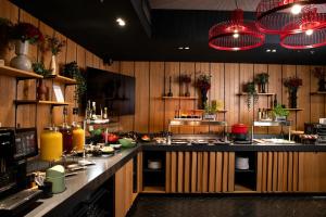a kitchen with wooden walls and a large counter top at Hotel Oktogon Haggenmacher by Continental Group in Budapest
