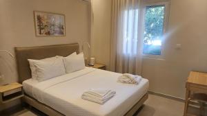 a bedroom with a bed with two towels on it at OASIS Central 007 in Rhodes Town