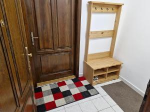 a room with a door and a rug next to a closet at Latran Apartments in Český Krumlov