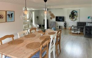 a dining room and living room with a wooden table at Nice Home In Slagelse With Wifi in Stillinge Strand