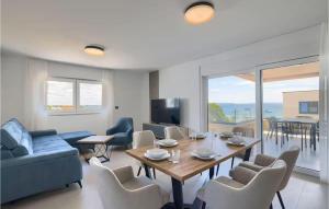 a living room with a table and chairs and a tv at Beautiful Apartment In Privlaka in Glavan