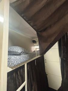 a bedroom with a bunk bed and a window at Kapoor dormitory in Mumbai