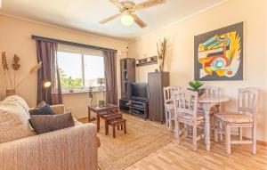 a living room with a couch and a table at Stunning Home In Orihuela Costa in Villamartin