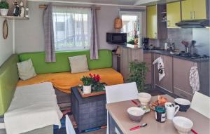 a living room and kitchen with a bed in a caravan at 3 Bedroom Nice Stacaravan In Trégunc in Trébérouant