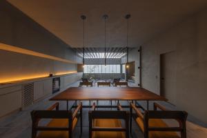 a dining room with a large wooden table and chairs at villa OCTOPORTO yobuko in Karatsu