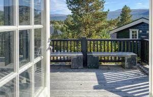 a bench sitting on the deck of a house at Pet Friendly Home In Bjorli With Sauna in Bjorli +34 photos