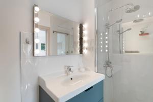 a white bathroom with a sink and a mirror at Modern Loft Las Palmas views 2 suit in Ciudad Jardín +19 photos