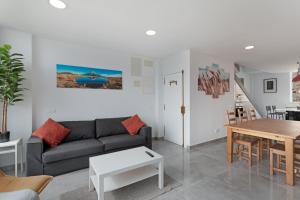 a living room with a couch and a table at Modern Loft Las Palmas views 2 suit in Ciudad Jardín