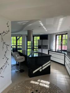 a kitchen with a black counter top in a room at Willa Solina in Solina