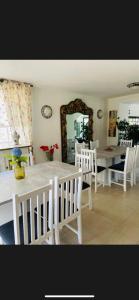 a dining room with a table and chairs and a mirror at Willa Solina in Solina +2 photos