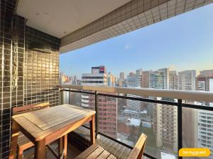a balcony with a wooden table and a view of a city at Landscape melhores apartamentos da Beira Mar in Fortaleza