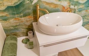 a bathroom with a white sink on a counter at Apartment Karbuni Royal by Villas Guide in Brnistrova +9 photos