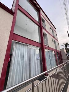 a building with large windows and a balcony at Pousada Bela By Bia - Comfort in Penha