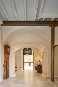 a large room with an archway in a building at Villa Cas Pilot Casa Mallorquina del Siglo XVIII NEW OPENING in Son Servera