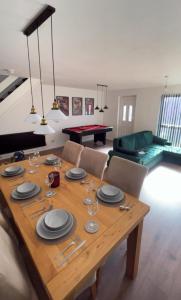a dining room with a table with plates and wine glasses at Sofi's Stay, Cosy 3 bed house, 5 mins Walk to Leeds City Centre in Leeds