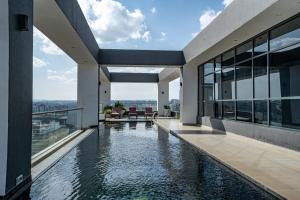 an external view of a house with a swimming pool at Escada Studio & 2-bedroom, Rooftop Lounge & Restaurant, Swimming Pool, Gym, Workspace, Wonderiss Properties Westlands Living in Nairobi