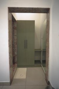 a bathroom with a glass cabinet in a room at Prem Sadan, Pandokhar Sarkar Dham in Indargarh +27 photos
