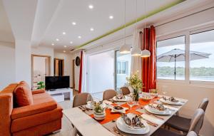 a dining room with a table and chairs and a couch at Apartment President by Villas Guide in Brnistrova