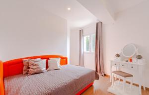 a bedroom with an orange bed and a white desk at Apartment President by Villas Guide in Brnistrova
