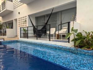 a villa with a swimming pool and a house at Adults Only Condo Close to the Beach in Acapulco