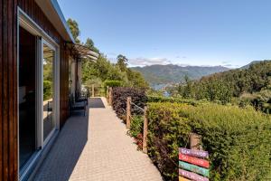 a porch of a house with a view of the mountains at Quintinha Da Aldida - Gerês in Vieira do Minho