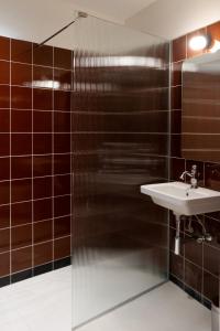 a bathroom with a sink and a mirror at Atla Living Athens in Athens