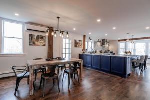 a kitchen and dining room with a table and chairs at The Old Bell Tavern - Luxury Meets History in New Gloucester