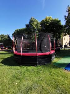a trampoline in the grass in a park at Apartamenty rodzinne przy plaży in Kołobrzeg