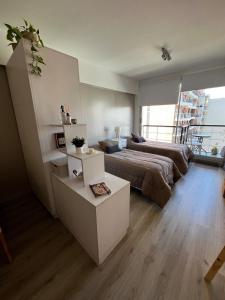 a large bedroom with a bed and a table at Urquiza Suite Premium Rental in Buenos Aires