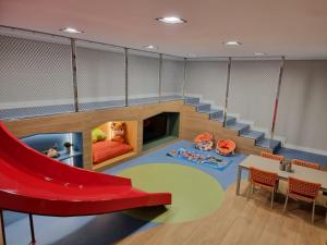 a childrens room with a slide and a table and chairs at Flat Elegante c/ Varanda e Vista Mar - Tambaú in Tambaú