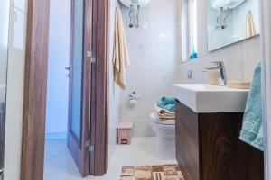 a bathroom with a sink and a toilet at New Spacious Apartment 3 Bdr 2 Bth Bugibba S in St Paul's Bay +50 photos