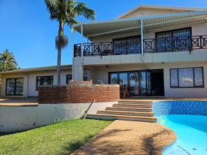 a house with a swimming pool in front of it at Margate Sunrise Seaview Secure Home - FAMILY ONLY, NO GROUPS in Margate