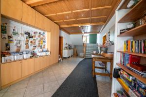 a hallway with wooden walls and a book shelf at Allgäutraum Ferienwohnung Nr 4 in Kempten