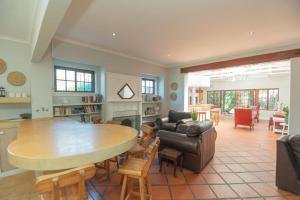 a kitchen and living room with a table and chairs at Casa Verde 142 in Gqeberha