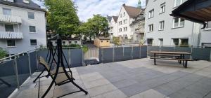 Una cámara en un trípode en un balcón con un banco. en Suite in Siegens Oberstadt, en Siegen