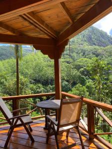a porch with two chairs and a table and a view at Villa Vanilla in Port Glaud +21 photos
