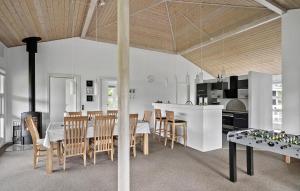 a kitchen and dining room with a table and chairs at Nice Home In Tarm With Sauna in Højsand