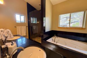 a bathroom with a tub and a sink and a bath tub at Tahoe Boulders in Stateline +15 photos