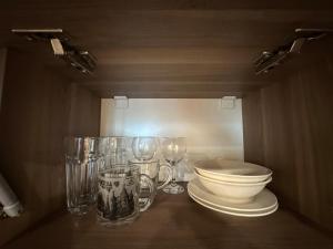 a bathroom with glasses and a toilet on a table at Beautiful apartments near the sea Adlia street in Batumi +71 photos