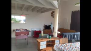 a living room with a couch and a table at Loft piscine chauffée et couverte in Sauvignac