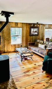 a living room with a couch and a table at Historic Parks Ranch Cabin near Williams in Parks +30 photos