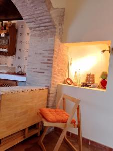 a kitchen with a table and a chair in a room at Villa Mayxar in Almáchar