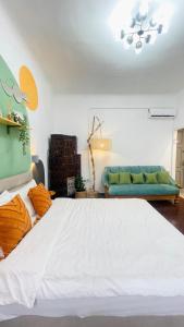 a bedroom with a large white bed and a couch at Стильна квартира з кондиціонером в центрі міста in Chernivtsi +13 photos