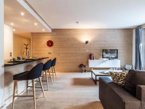 a living room with a couch and a table at Appartement centre-ville, proche pistes et commerces, 6 pers., 2 ch., balcon, parking inclus - FR-1-519-5 in Val dʼIsère +11 photos