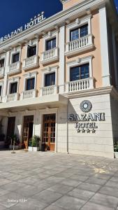 a large building with a sign in front of it at Sazani Hotel in Vlorë