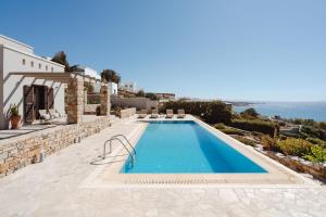 a swimming pool on the side of a villa at ZELION VILLA in Stelida