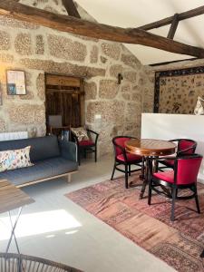 a living room with a table and chairs at Villa Seara - Casas da Vinha in Celorico de Basto