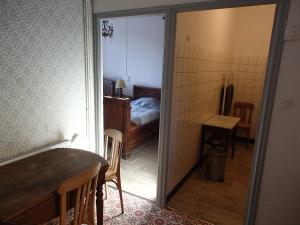 a room with a room with a bed and a table at Appartement Authentique Montaigut in Montégut +2 photos